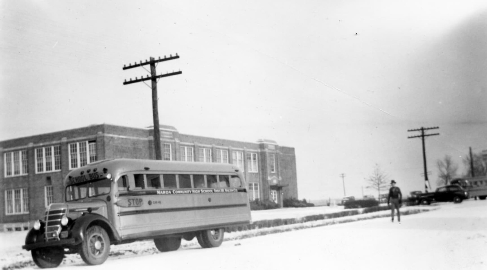 Maroa Community High School and a school bus in the snow in 1940